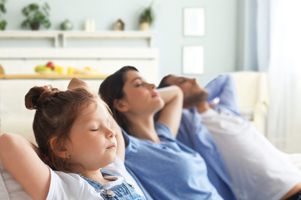 Relaxed Young Family Resting Cool House
