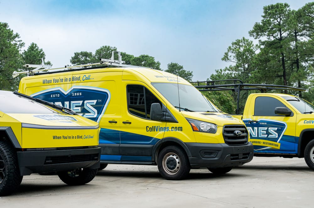 Vines Heating and Air commercial service vehicles parked on site, representing commercial HVAC and plumbing support for businesses in South Carolina.