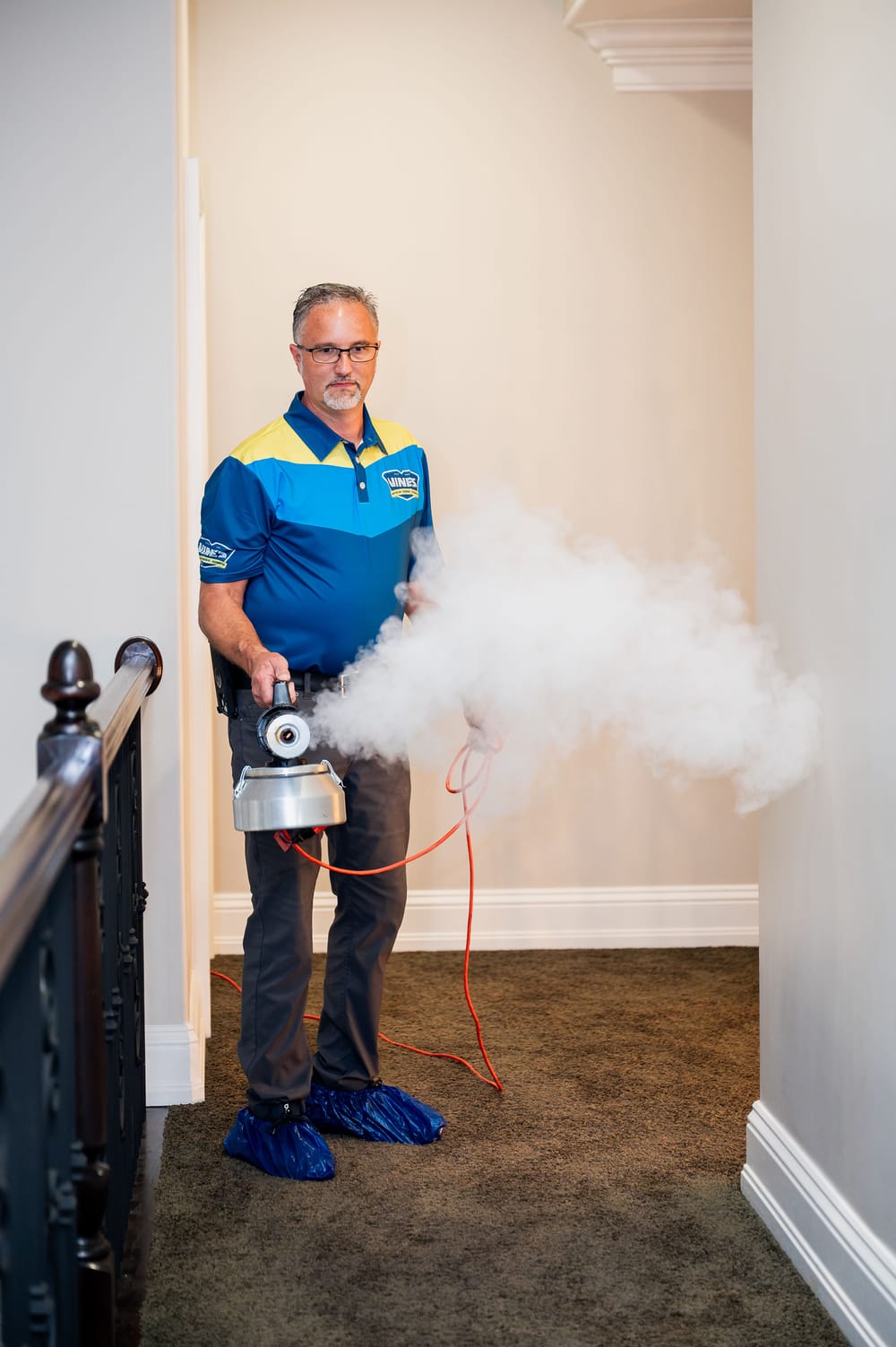 Vines technician conducting fire restoration with a disinfectant.