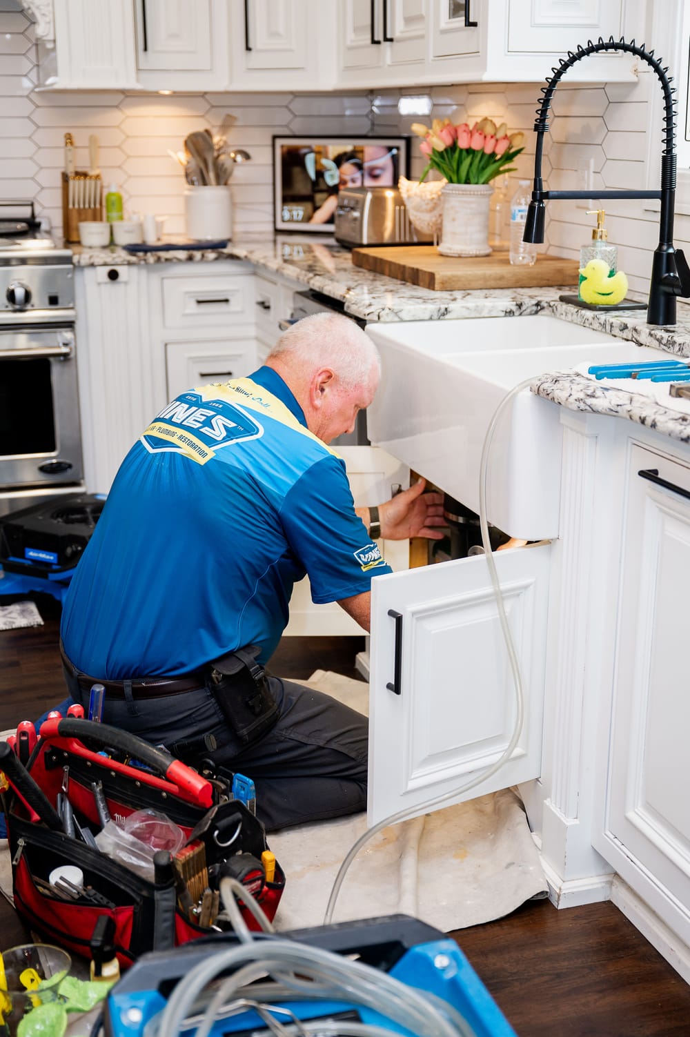 Vines technician performing kitchen plumbing in Myrtle Beach, SC