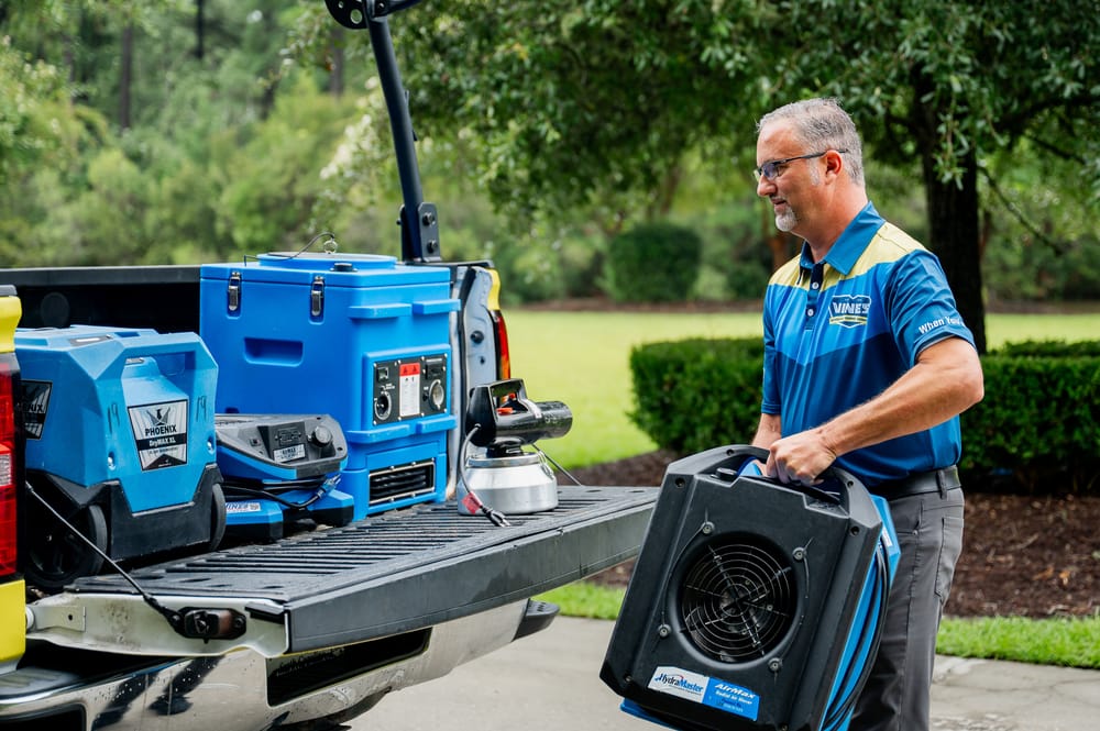 Vines technician unloading restoration equipment from truck.