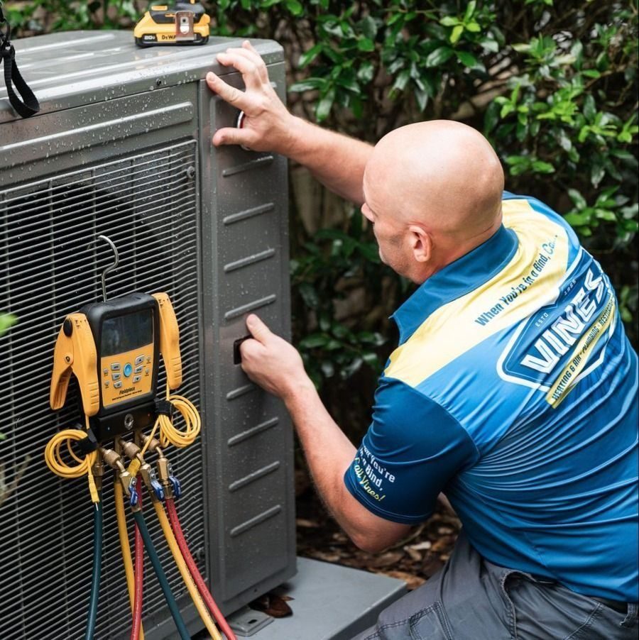 Vines tech performing a routine tune-up on an AC unit